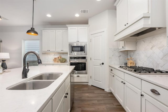 200 Wild Sage Ln, Liberty Hill, TX 78642 - kitchen featuring appliances with stainless steel finishes, a sink, white cabinetry, light countertops, and recessed lighting