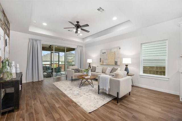 200 Wild Sage Ln, Liberty Hill, TX 78642 - living room with ceiling fan, a raised ceiling, wood finished floors, recessed lighting, and baseboards