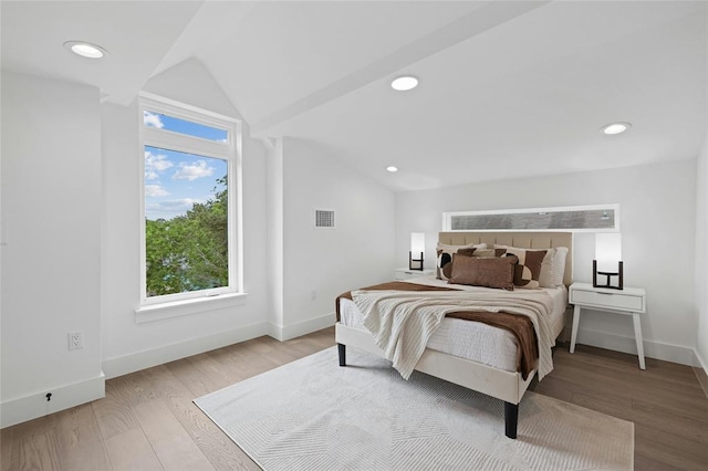 1117 Lawson Ln Unit 2, Austin, TX 78702 - bedroom featuring vaulted ceiling, wood finished floors, baseboards, and recessed lighting