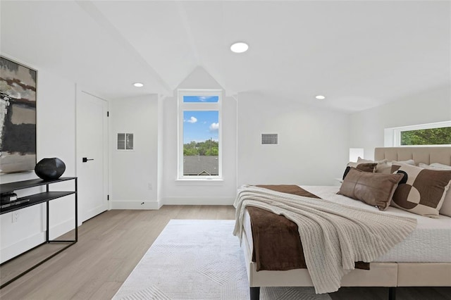 1117 Lawson Ln Unit 2, Austin, TX 78702 - bedroom featuring light wood-type flooring, vaulted ceiling, and recessed lighting