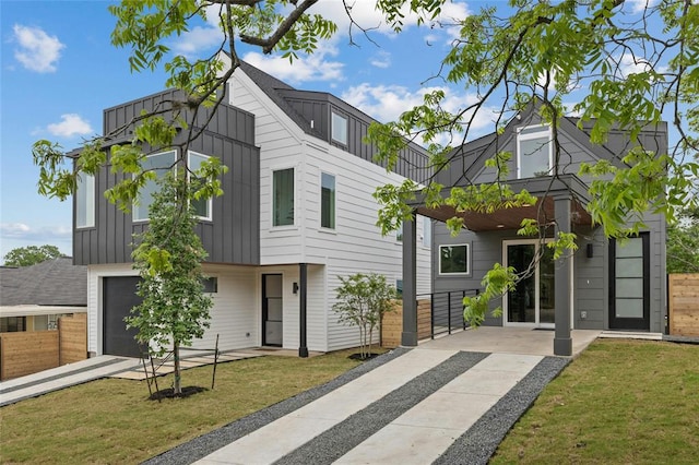 1117 Lawson Ln Unit 2, Austin, TX 78702 - contemporary house with board and batten siding, driveway, and an attached garage
