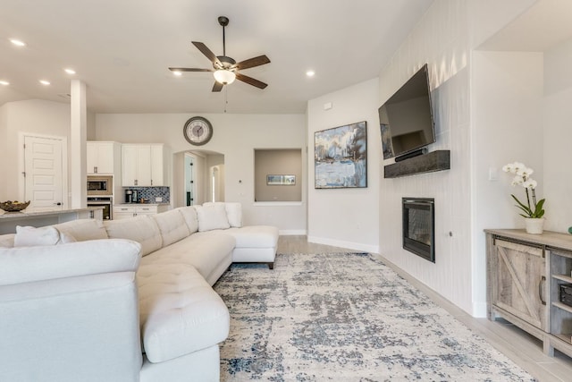 603 Arundel Rd, Austin, TX 78738 - living room with a ceiling fan, a fireplace, recessed lighting, arched walkways, and baseboards