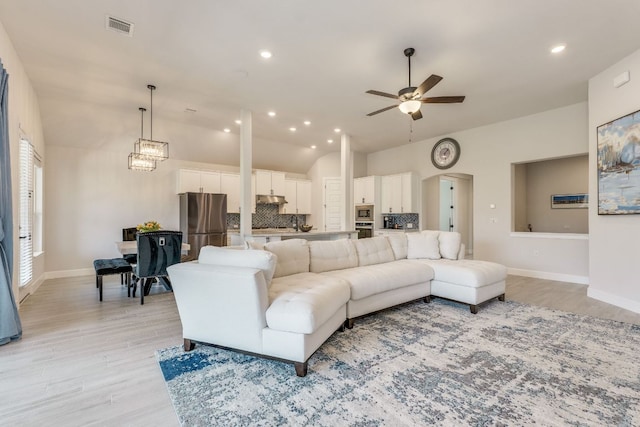 603 Arundel Rd, Austin, TX 78738 - living area featuring ceiling fan, vaulted ceiling, light wood-style flooring, baseboards, and recessed lighting