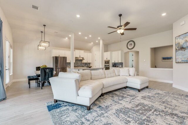 603 Arundel Rd, Austin, TX 78738 - living room featuring ceiling fan, lofted ceiling, light wood-type flooring, and recessed lighting