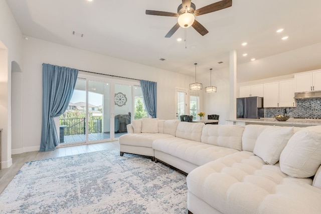 603 Arundel Rd, Austin, TX 78738 - living area featuring ceiling fan, recessed lighting, light wood-style flooring, arched walkways, and baseboards