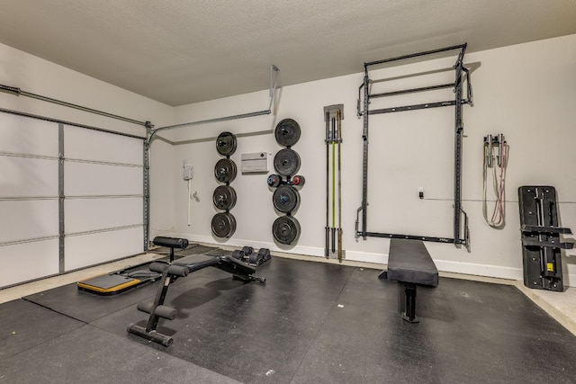 603 Arundel Rd, Austin, TX 78738 - workout room with baseboards, a textured ceiling, and a garage