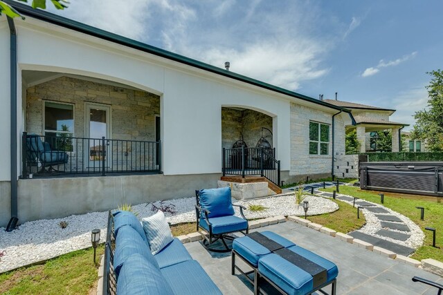 603 Arundel Rd, Austin, TX 78738 - rear view of property with stone siding, a hot tub, and a patio