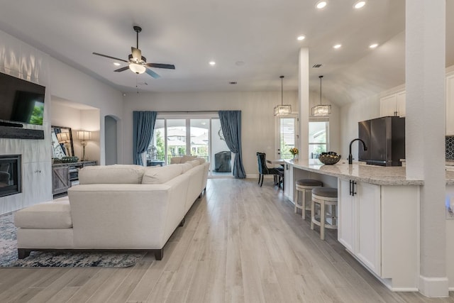 603 Arundel Rd, Austin, TX 78738 - living area featuring healthy amount of natural light, recessed lighting, light wood-type flooring, ceiling fan, and a tiled fireplace
