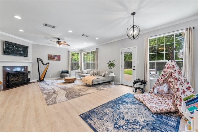 208 Sailors Run, Lakeway, TX 78734 - living area featuring ornamental molding, wood finished floors, baseboards, a fireplace with flush hearth, and recessed lighting