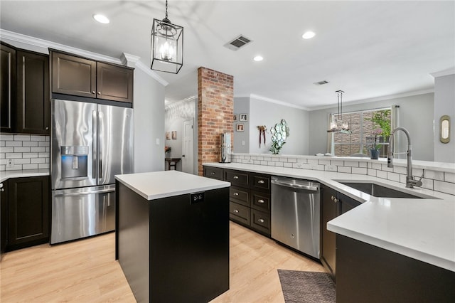 208 Sailors Run, Lakeway, TX 78734 - kitchen with appliances with stainless steel finishes, a sink, crown molding, backsplash, and light countertops