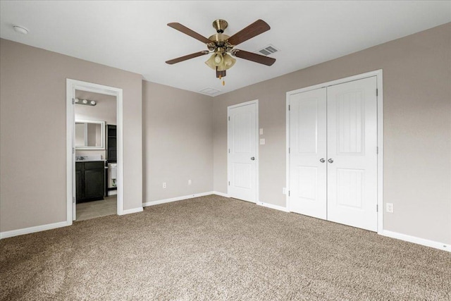 163 Wainscot Oak Way, San Marcos, TX 78666 - unfurnished bedroom with carpet, baseboards, a closet, connected bathroom, and ceiling fan