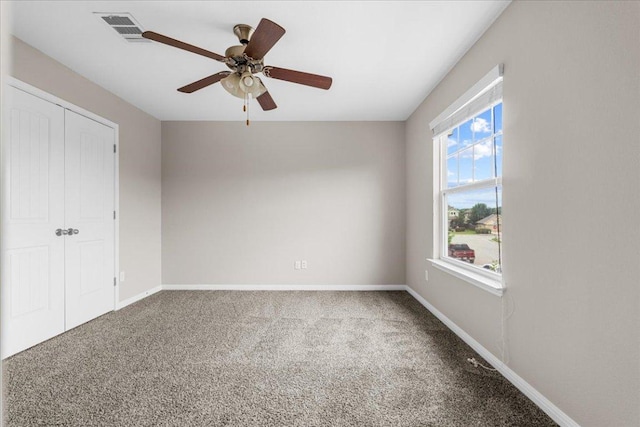 163 Wainscot Oak Way, San Marcos, TX 78666 - unfurnished bedroom with carpet flooring, baseboards, ceiling fan, and a closet