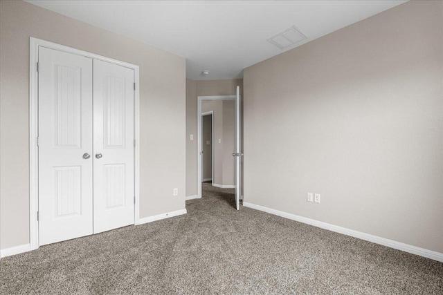 163 Wainscot Oak Way, San Marcos, TX 78666 - unfurnished bedroom featuring carpet flooring, a closet, and baseboards