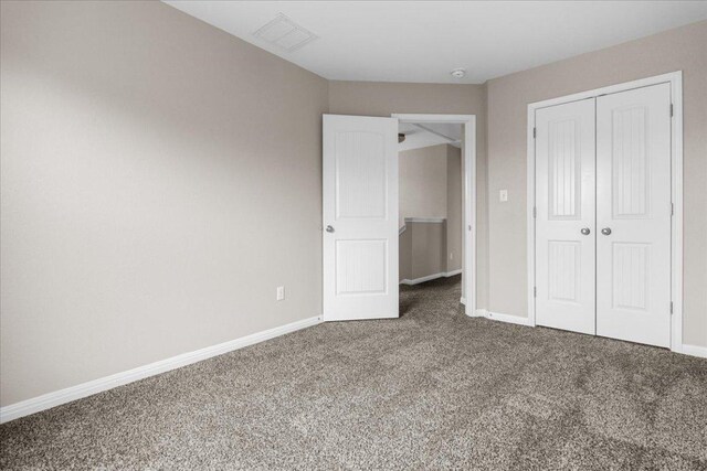 163 Wainscot Oak Way, San Marcos, TX 78666 - unfurnished bedroom featuring carpet flooring, a closet, and baseboards