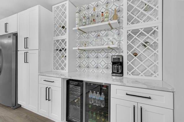 609 Blackberry Dr, Austin, TX 78745 - indoor dry bar with freestanding refrigerator, beverage cooler, and wood finished floors