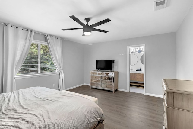609 Blackberry Dr, Austin, TX 78745 - bedroom featuring multiple windows, dark wood-style flooring, and baseboards