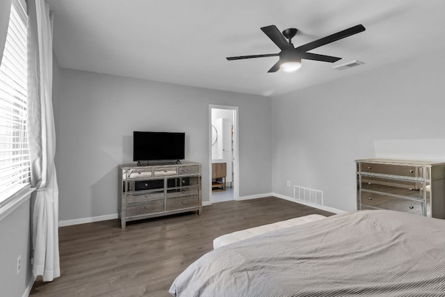 609 Blackberry Dr, Austin, TX 78745 - bedroom with baseboards, wood finished floors, ceiling fan, and connected bathroom