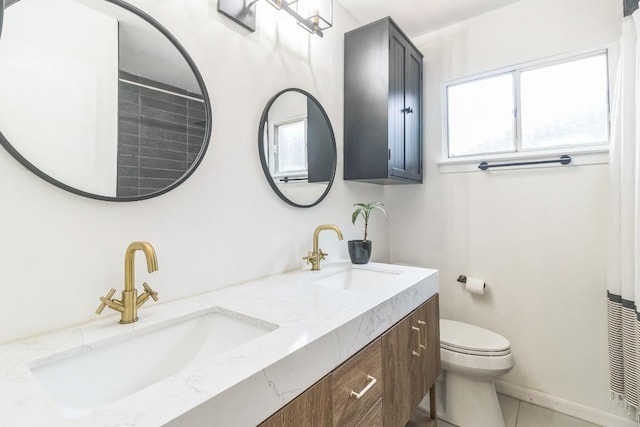 609 Blackberry Dr, Austin, TX 78745 - bathroom with double vanity and toilet