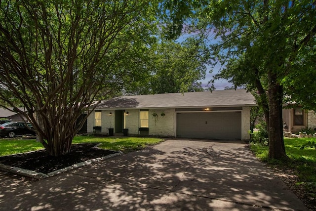 609 Blackberry Dr, Austin, TX 78745 - ranch-style home featuring concrete driveway, a garage, and a front yard