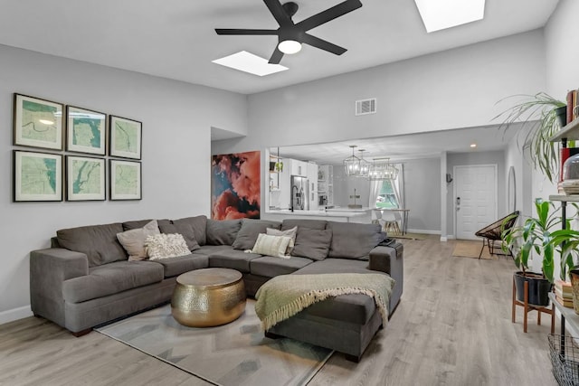 609 Blackberry Dr, Austin, TX 78745 - living area with a skylight, a ceiling fan, light wood-type flooring, baseboards, and high vaulted ceiling