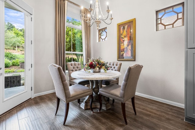 121 Cartwheel Bnd Unit 42, Austin, TX 78738 - dining area featuring a chandelier, baseboards, and dark wood-style flooring