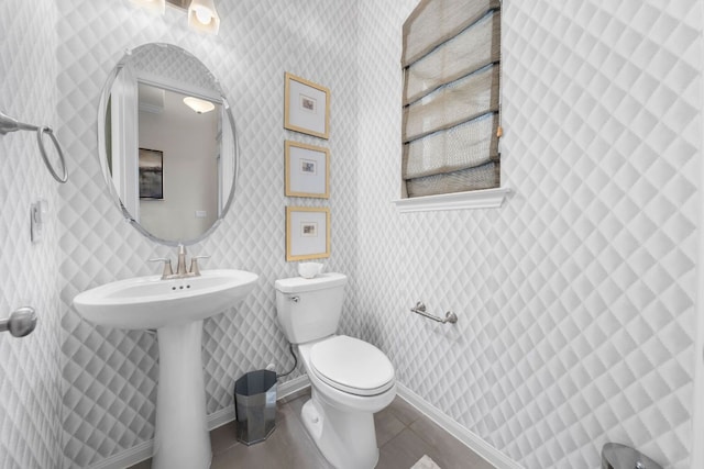 121 Cartwheel Bnd Unit 42, Austin, TX 78738 - half bath with toilet, tile patterned flooring, baseboards, wallpapered walls, and a sink