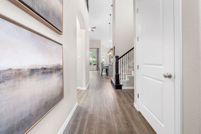 121 Cartwheel Bnd Unit 42, Austin, TX 78738 - hallway featuring dark wood-style flooring, baseboards, and stairway