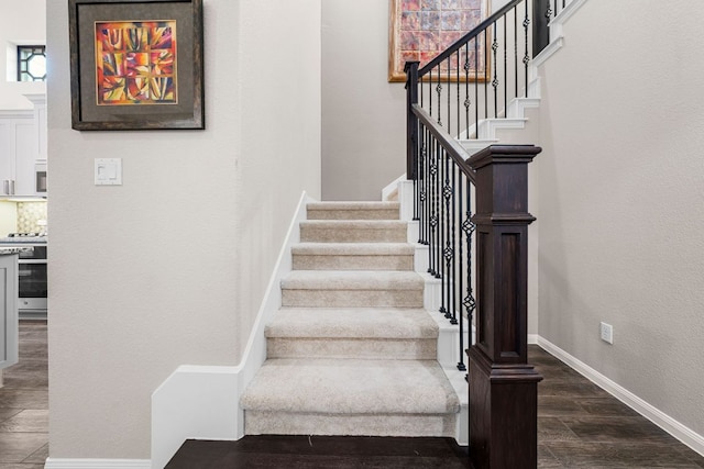 121 Cartwheel Bnd Unit 42, Austin, TX 78738 - staircase with wood finished floors, baseboards, and a textured wall