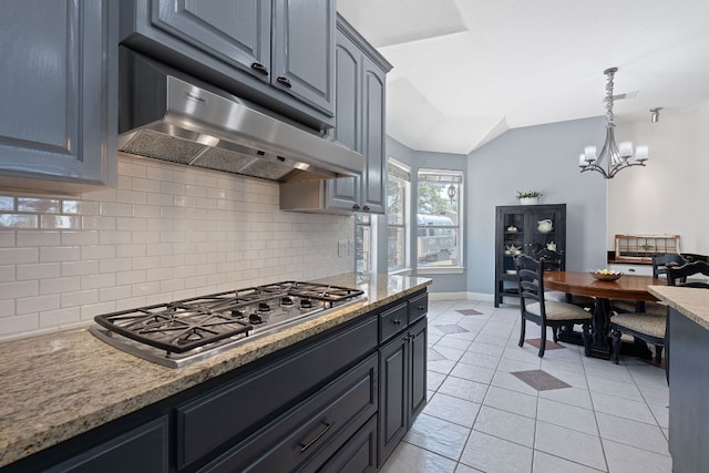 820 Morgan Hill Dr, Dripping Springs, TX 78620 - kitchen featuring under cabinet range hood, tasteful backsplash, stainless steel gas cooktop, baseboards, and light tile patterned floors