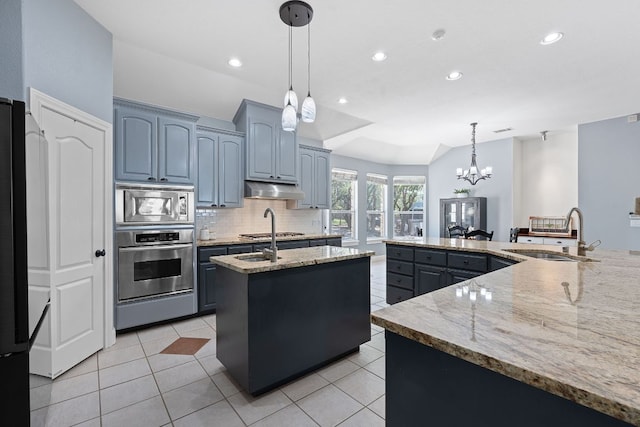 820 Morgan Hill Dr, Dripping Springs, TX 78620 - kitchen featuring stainless steel appliances, a sink, a spacious island, under cabinet range hood, and tasteful backsplash