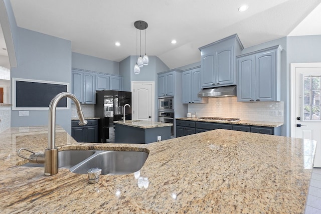 820 Morgan Hill Dr, Dripping Springs, TX 78620 - kitchen with stainless steel appliances, under cabinet range hood, light stone countertops, a sink, and backsplash