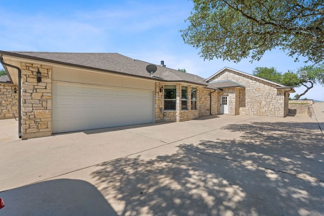 820 Morgan Hill Dr, Dripping Springs, TX 78620 - single story home with stone siding, concrete driveway, and an attached garage