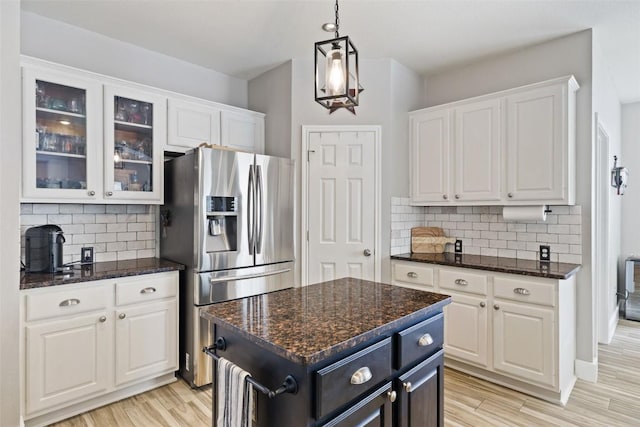 2021 Kimbrook Dr, Round Rock, TX 78681 - kitchen featuring stainless steel refrigerator with ice dispenser, white cabinets, glass insert cabinets, decorative backsplash, and light wood-style flooring