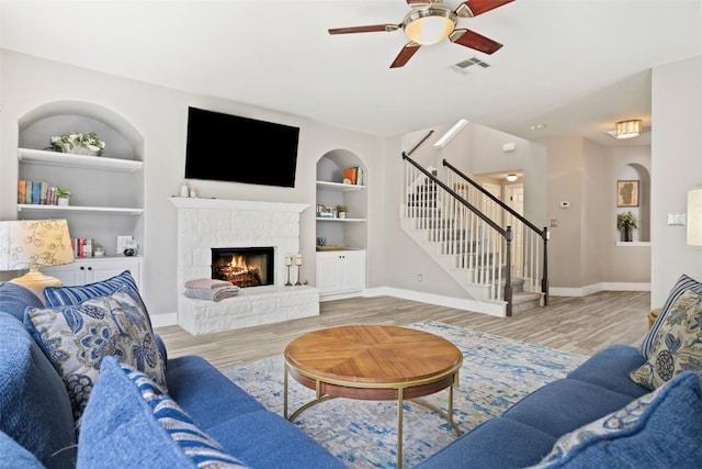 2021 Kimbrook Dr, Round Rock, TX 78681 - living area with stairs, built in shelves, ceiling fan, and wood finished floors