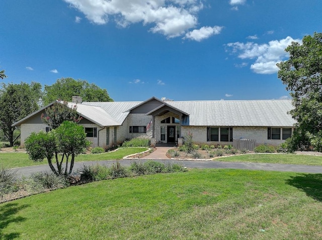 3514 Fm 3509, Burnet, TX 78611 - view of front of house featuring metal roof, a front yard, and a chimney