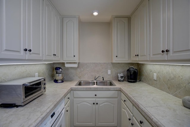 3514 Fm 3509, Burnet, TX 78611 - kitchen featuring a sink, white cabinetry, light countertops, and backsplash