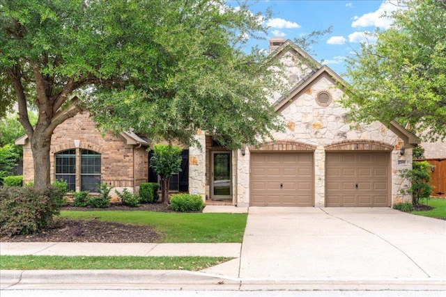 2709 Sun Mountain Dr, Leander, TX 78641 - view of front of house featuring an attached garage, stone siding, concrete driveway, and a chimney