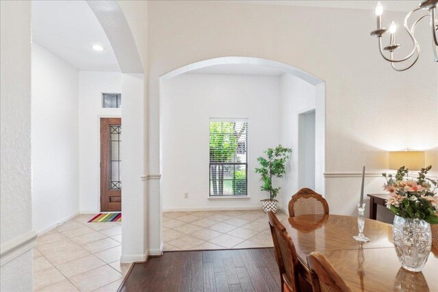 2709 Sun Mountain Dr, Leander, TX 78641 - dining space featuring arched walkways, hardwood / wood-style floors, and a chandelier
