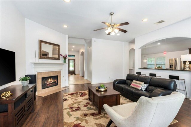 2709 Sun Mountain Dr, Leander, TX 78641 - living area featuring arched walkways, ceiling fan, a fireplace, recessed lighting, and wood finished floors