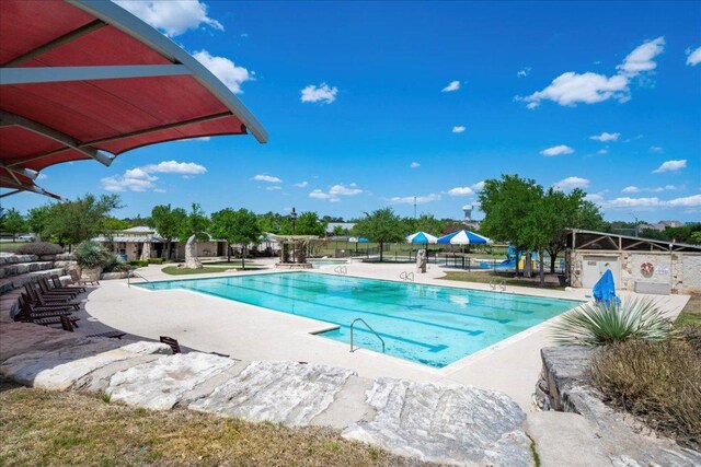 2709 Sun Mountain Dr, Leander, TX 78641 - community pool featuring a patio