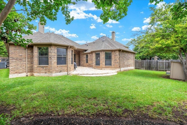 2709 Sun Mountain Dr, Leander, TX 78641 - rear view of property with a chimney, a fenced backyard, brick siding, and a patio area