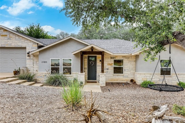 21800 Owens Cv, Lago Vista, TX 78645 - ranch-style house featuring stone siding, roof with shingles, stucco siding, and a garage
