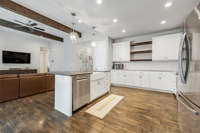 21800 Owens Cv, Lago Vista, TX 78645 - kitchen featuring appliances with stainless steel finishes, open floor plan, dark wood finished floors, open shelves, and recessed lighting