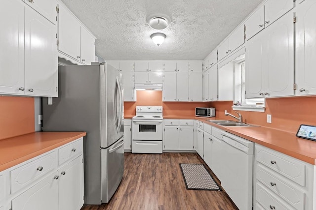 237 Oak Park Two, Rockdale, TX 76567 - kitchen featuring white appliances, under cabinet range hood, a textured ceiling, a sink, and white cabinetry
