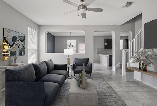 144 Holstein St, Hutto, TX 78634 - living area featuring ceiling fan, arched walkways, and stairs