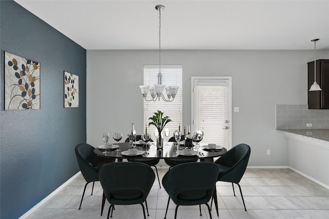 144 Holstein St, Hutto, TX 78634 - dining area with a chandelier and light tile patterned floors