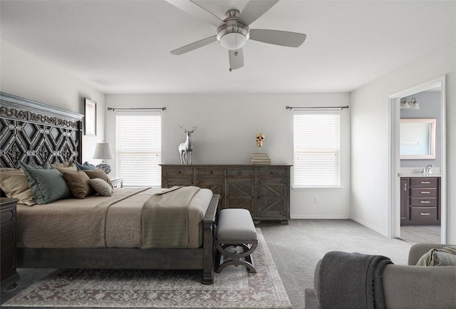 144 Holstein St, Hutto, TX 78634 - bedroom with multiple windows, light carpet, ensuite bathroom, and a ceiling fan