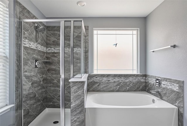 144 Holstein St, Hutto, TX 78634 - full bathroom featuring a garden tub and a shower stall