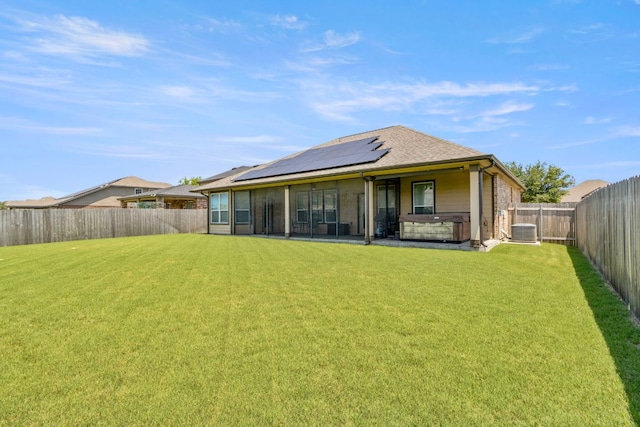 18401 Pencil Cactus Dr, Pflugerville, TX 78660 - back of property with a hot tub, a fenced backyard, and solar panels