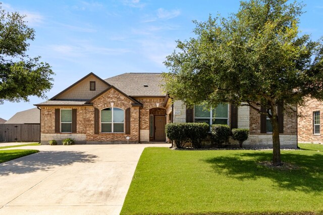 18401 Pencil Cactus Dr, Pflugerville, TX 78660 - view of front facade featuring brick siding, driveway, and roof with shingles